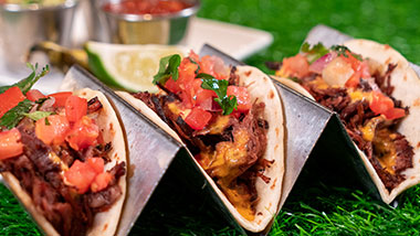 three chicken tacos topped with pico de gallo