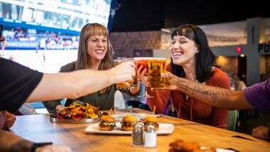 women smiling with beer glasses