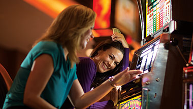 2 women playing the slots